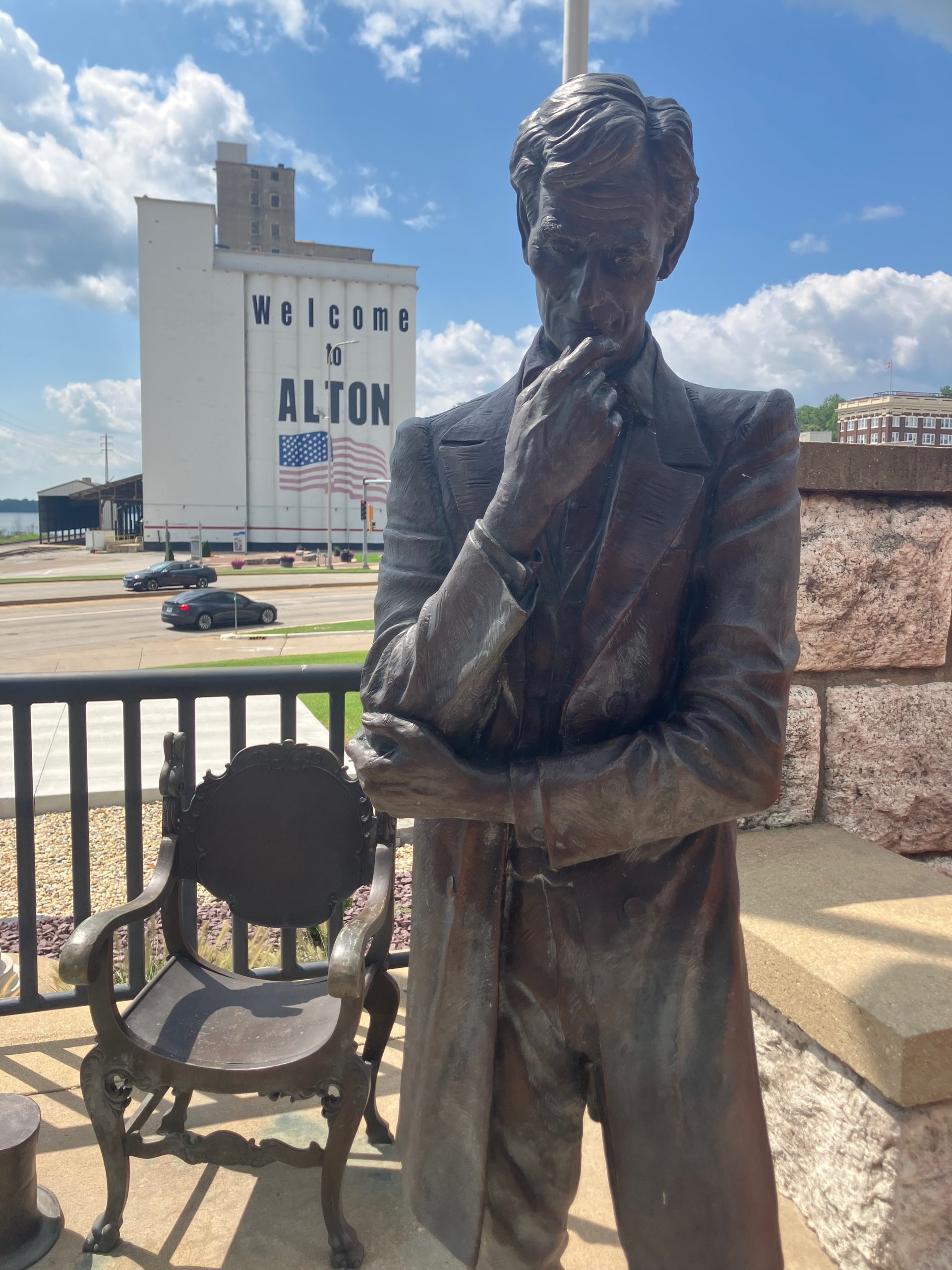 Sculpture commemorating the Lincoln/Douglas debate in Alton, with the iconic "Welcome to Alton" mural in the background.
